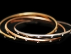 Three gold bracelets  isolated on the white